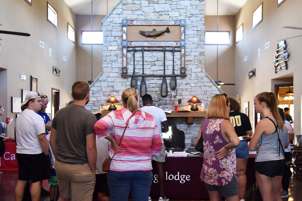 Parents and students wait in line to fill out their paperwork for their rooms in Campus Lodge